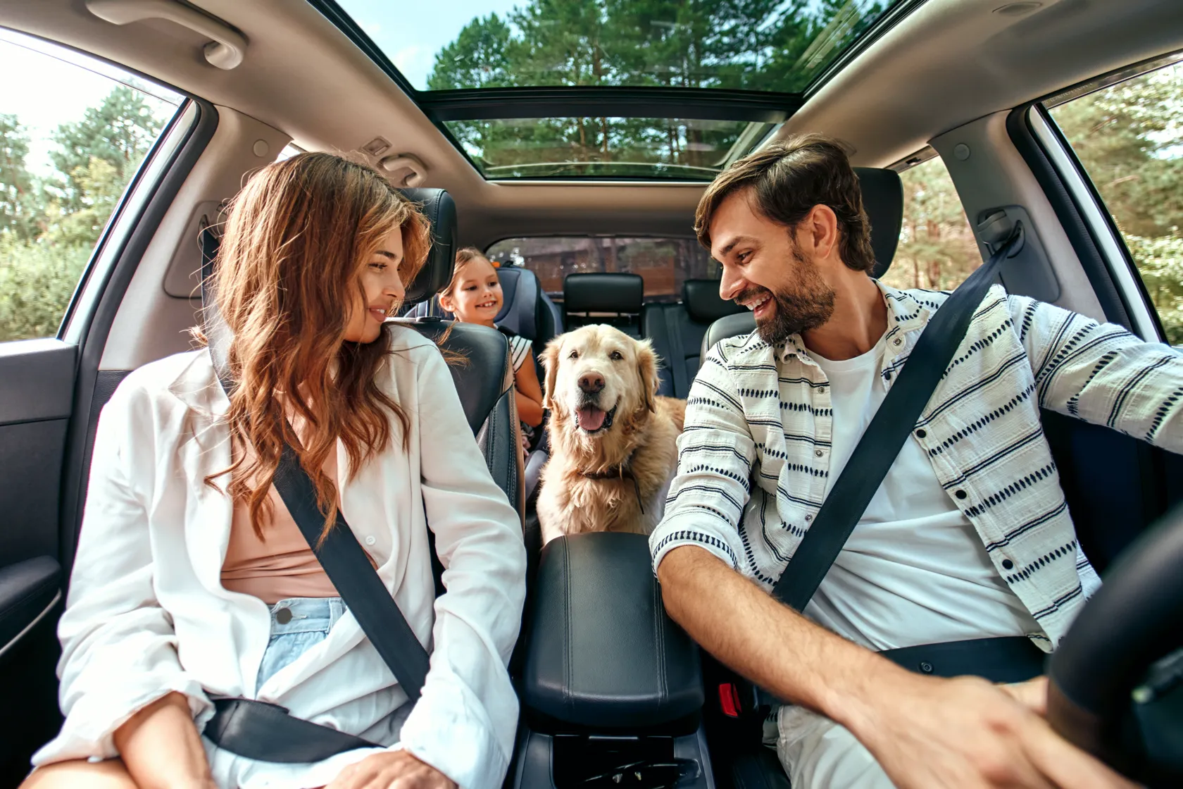Family in car with pet
